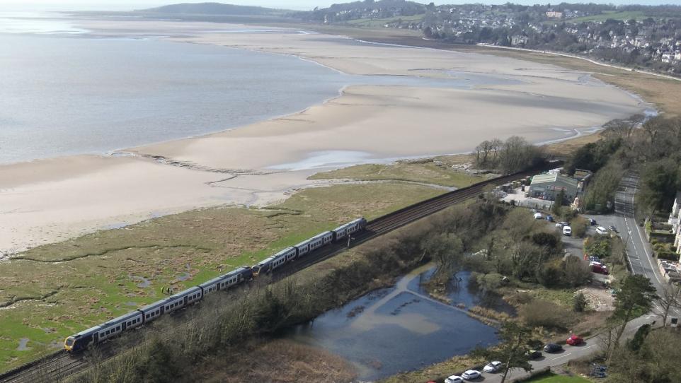 The train seen from above with Morecambe Bay and Grange in the background (Image: Network Rail)